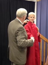 Dalton Superintendent Jim Hawkins helps get the robe adjusted for Park Creek kindergarten student Ethan Dempsey as they prepare to make the photo for the Class of 2026.